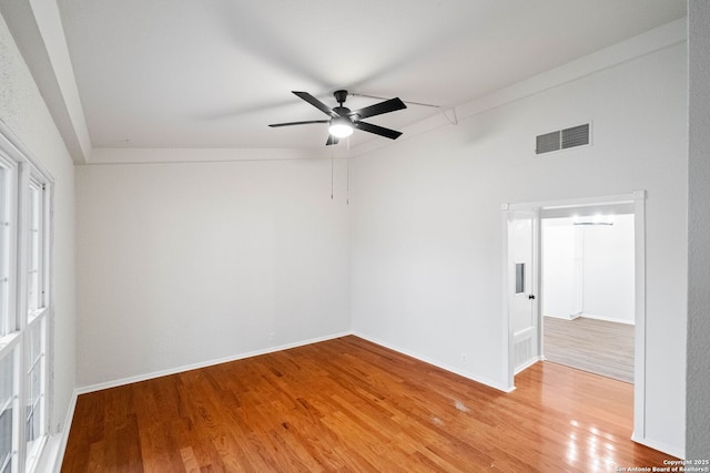 empty room with ceiling fan and hardwood / wood-style floors