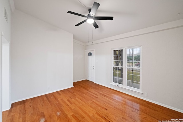 empty room with light hardwood / wood-style floors and ceiling fan