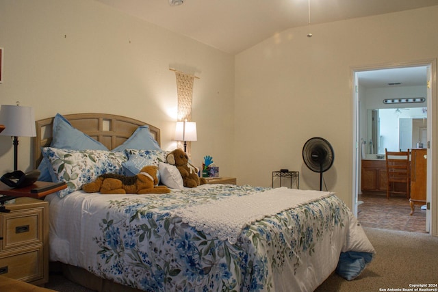 bedroom with lofted ceiling and connected bathroom