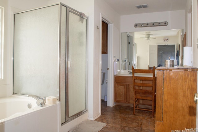 bathroom with ceiling fan, vanity, and plus walk in shower