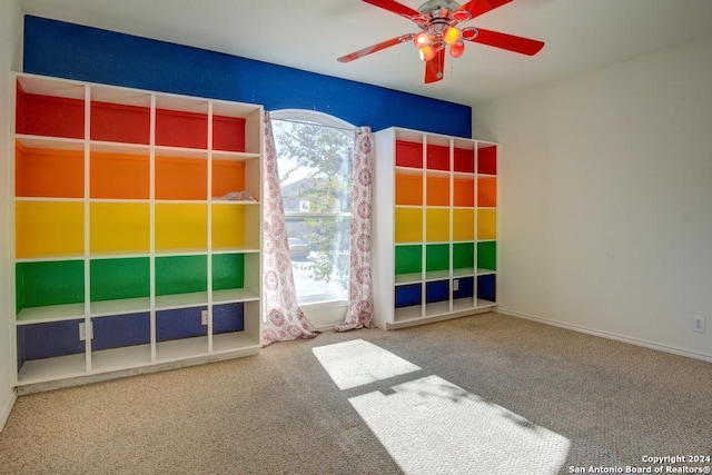 unfurnished room with ceiling fan, a wealth of natural light, and carpet floors