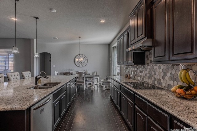 kitchen featuring dishwasher, sink, black electric cooktop, and pendant lighting