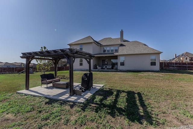 back of property featuring a pergola, a patio area, and a lawn