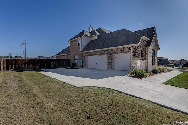 view of side of home featuring a lawn and central AC