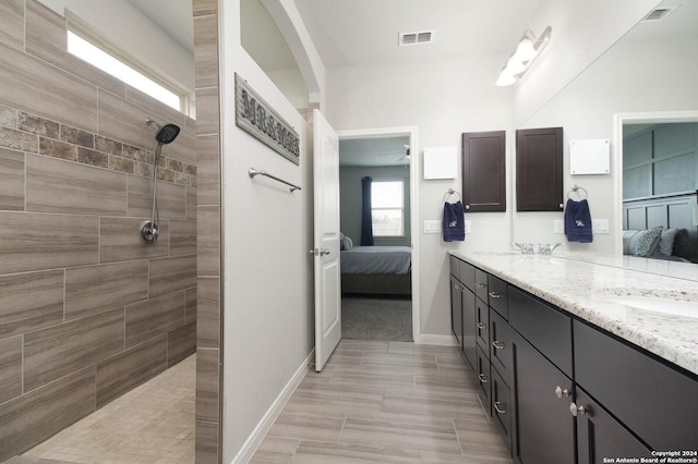 bathroom featuring vanity and a tile shower