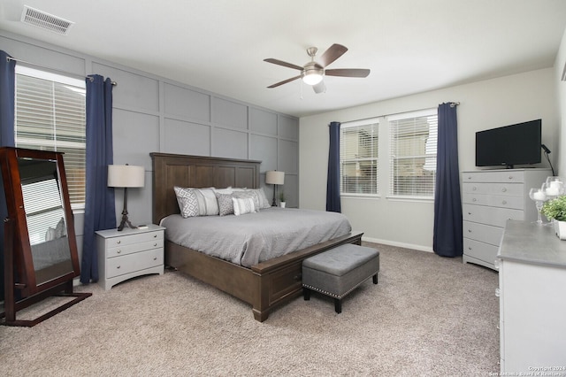 bedroom with light carpet and ceiling fan