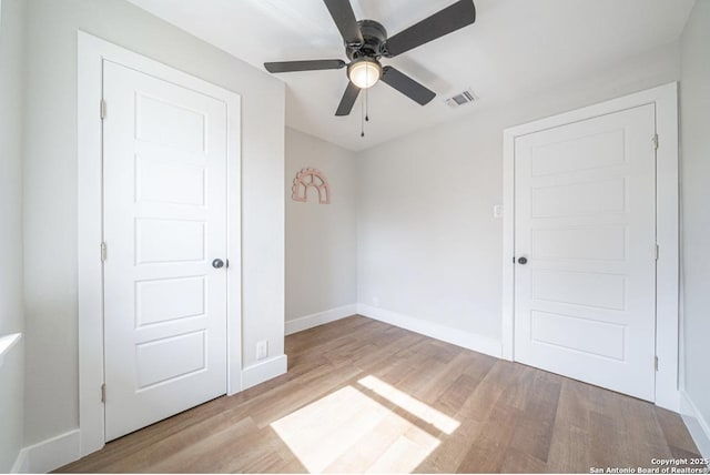 unfurnished bedroom featuring ceiling fan and light hardwood / wood-style flooring