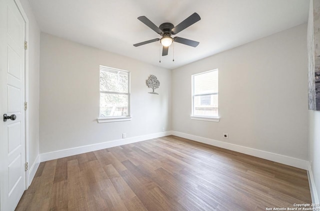 unfurnished room with ceiling fan, wood-type flooring, and plenty of natural light