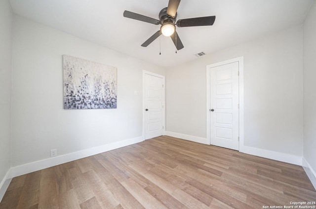 unfurnished room featuring light wood-type flooring and ceiling fan