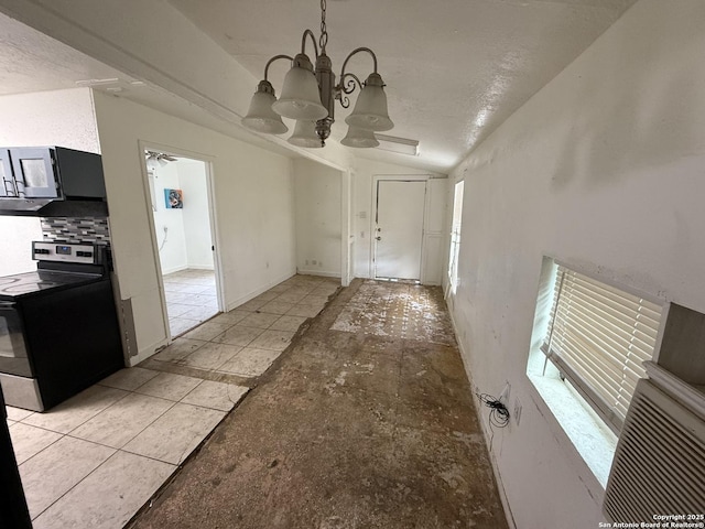 unfurnished dining area featuring vaulted ceiling, a notable chandelier, and a wealth of natural light