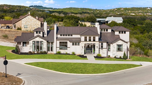 modern inspired farmhouse with a front lawn