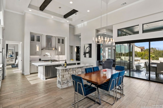 dining room with a high ceiling, crown molding, and a notable chandelier