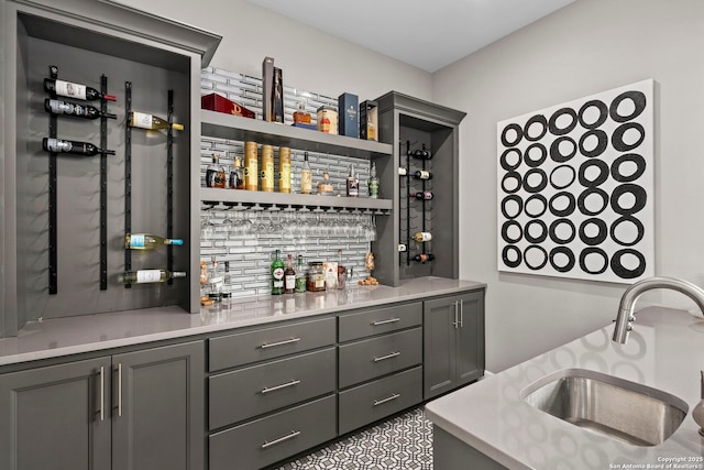 bar with sink and gray cabinets