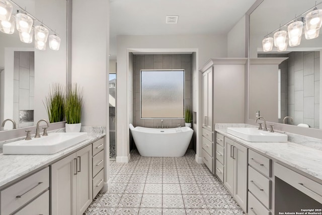 bathroom with a bath and vanity