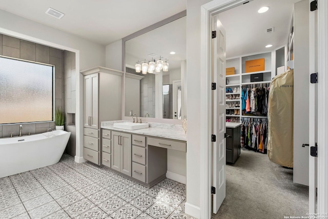 bathroom with vanity and a tub