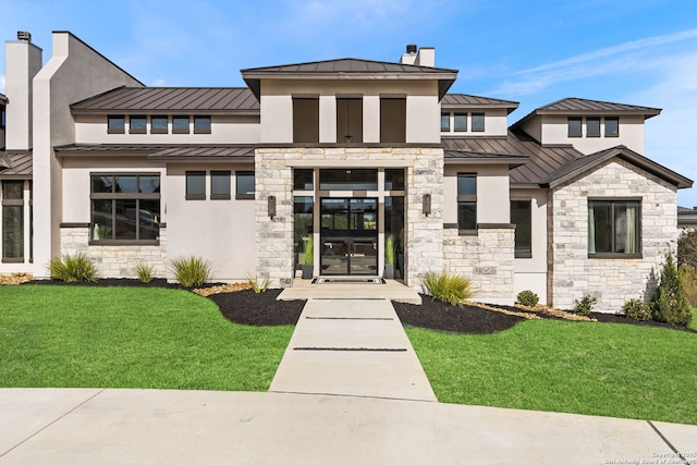 view of front facade with a front lawn and french doors