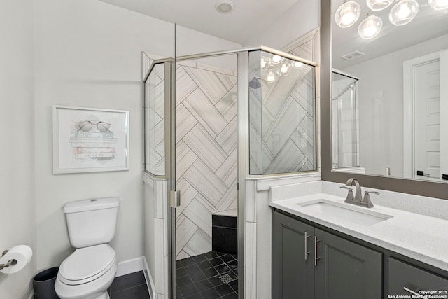 bathroom featuring toilet, tile patterned floors, a shower with door, and vanity