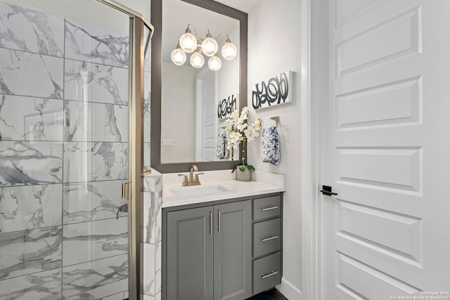 bathroom featuring a shower with shower door and vanity