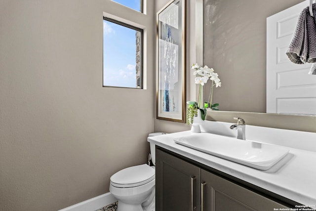 bathroom featuring toilet and vanity