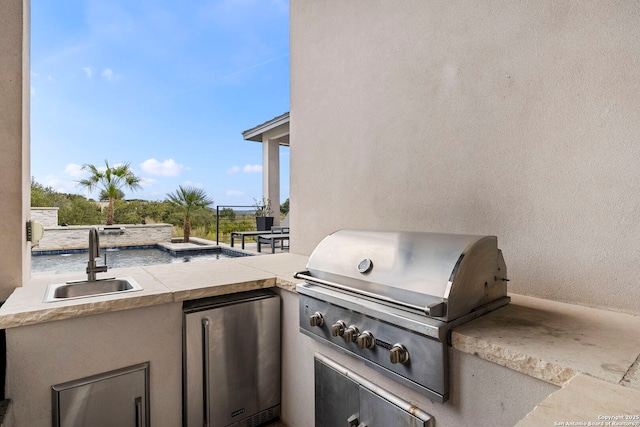 view of patio featuring a grill, exterior kitchen, and sink