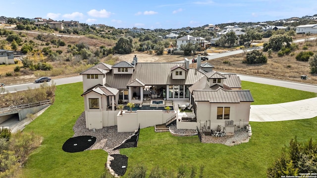 back of house featuring a lawn