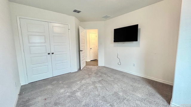 unfurnished bedroom featuring carpet floors and a closet