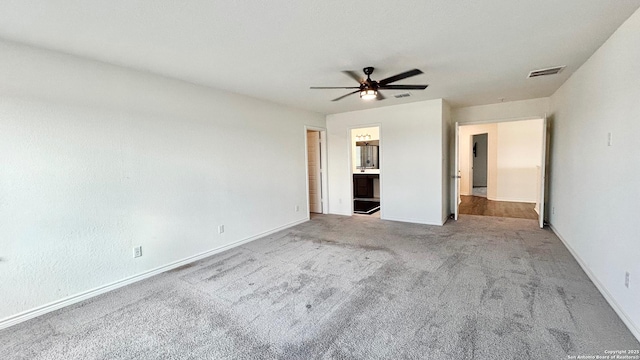 unfurnished bedroom featuring light carpet, ceiling fan, and connected bathroom