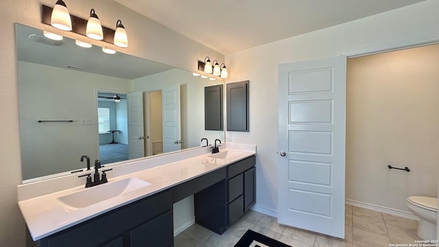 bathroom featuring toilet, ceiling fan, tile patterned floors, and vanity