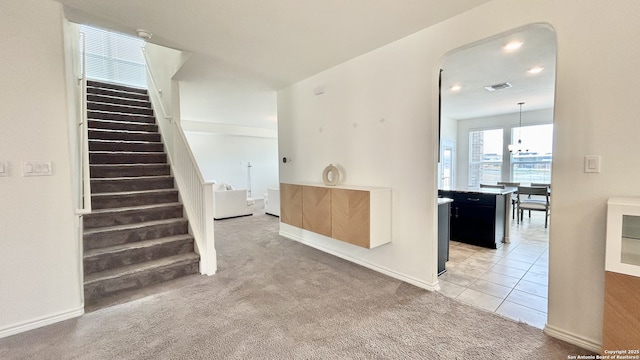 interior space featuring an inviting chandelier and carpet floors