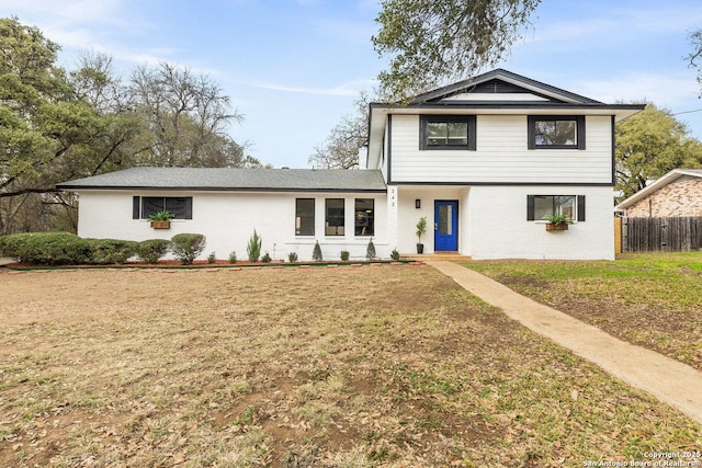 view of property featuring a front lawn