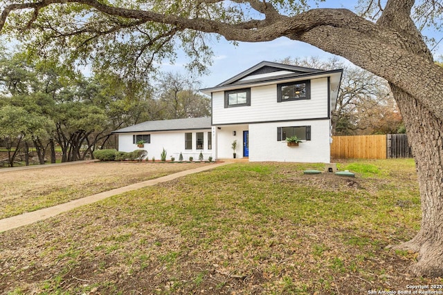 view of property featuring a front lawn