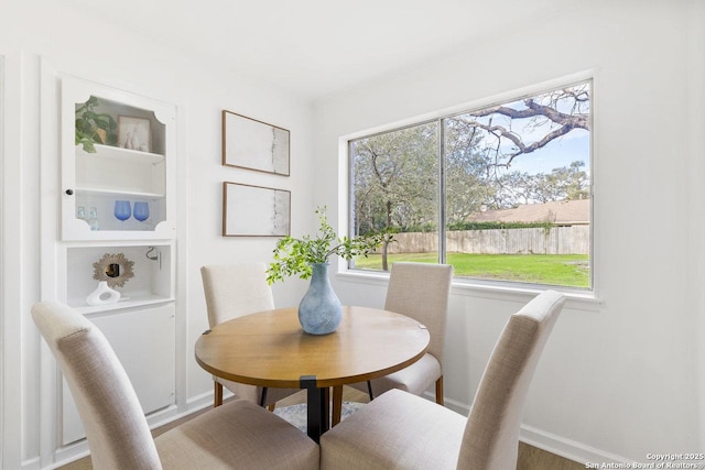 dining room featuring a healthy amount of sunlight and built in features