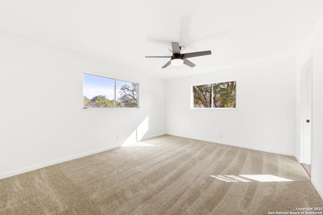 spare room featuring ceiling fan and light colored carpet