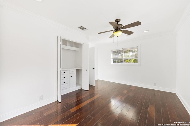 empty room featuring ceiling fan, dark hardwood / wood-style floors, and ornamental molding