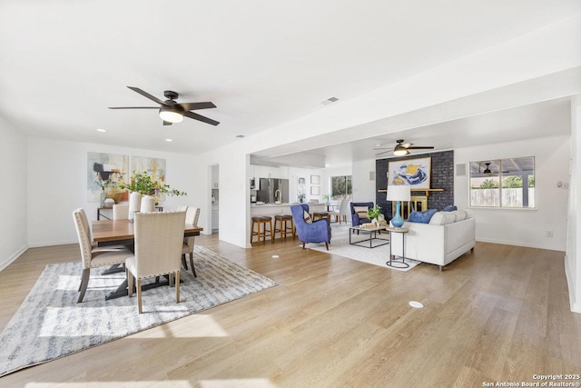 dining space featuring ceiling fan and light wood-type flooring