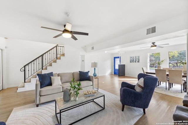 living room with ceiling fan and light hardwood / wood-style floors