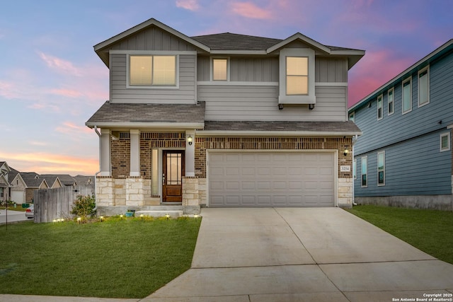 view of front of home with a garage and a yard