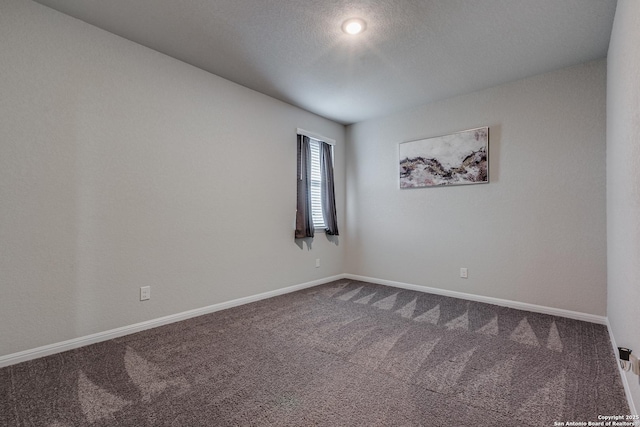 unfurnished room featuring carpet floors and a textured ceiling