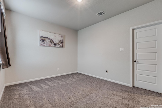 carpeted empty room with a textured ceiling