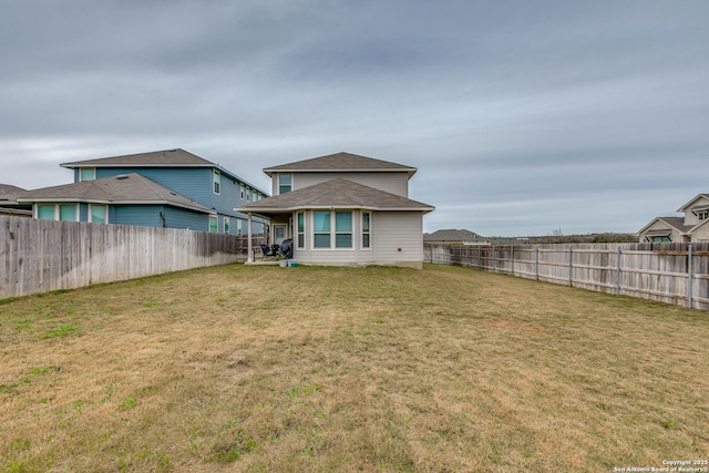 rear view of house with a lawn