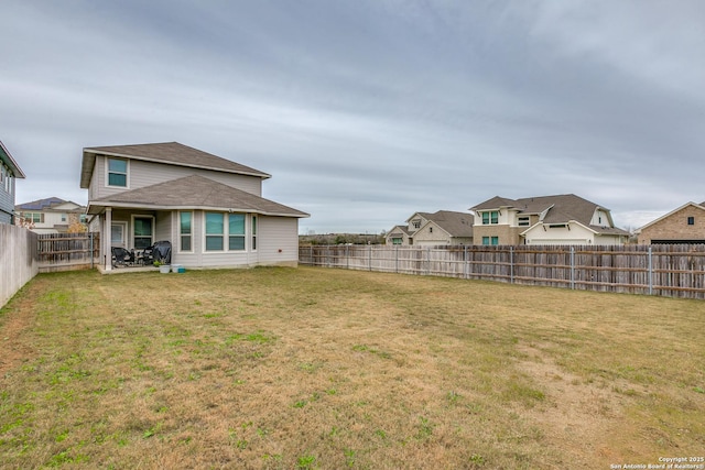 back of house with a yard