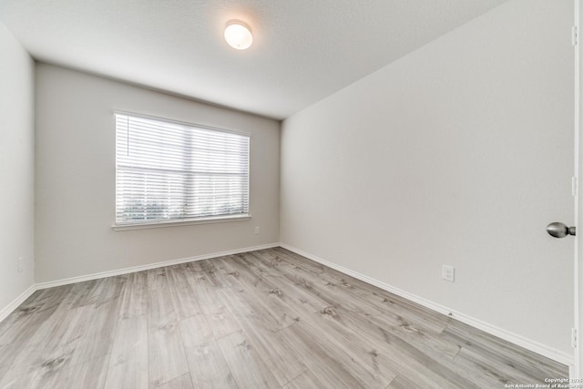 spare room with light hardwood / wood-style floors