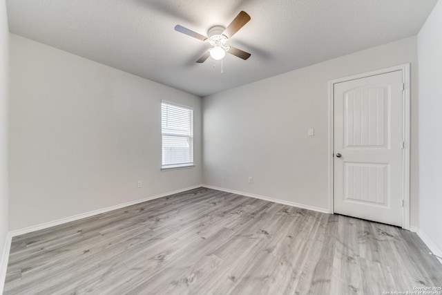 unfurnished room featuring ceiling fan, a textured ceiling, and light hardwood / wood-style flooring