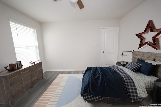 bedroom with ceiling fan and dark hardwood / wood-style flooring