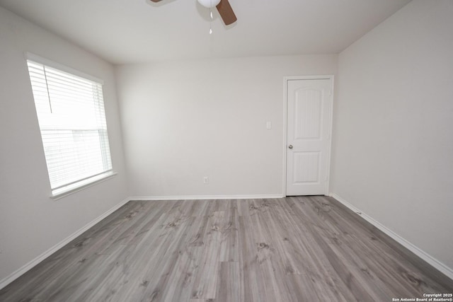 unfurnished room with ceiling fan and light wood-type flooring