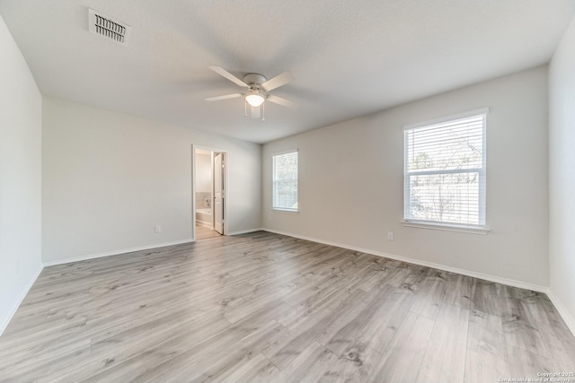 spare room with ceiling fan, a textured ceiling, and light hardwood / wood-style flooring