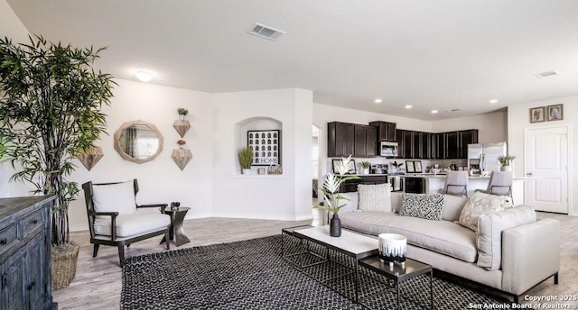 living room with light hardwood / wood-style flooring