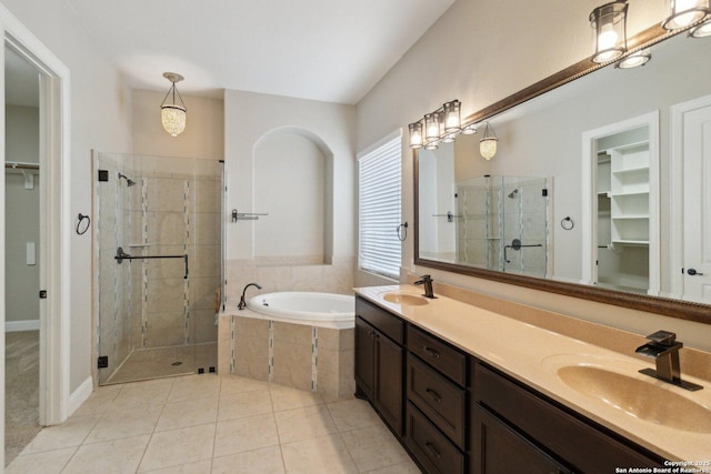 bathroom featuring shower with separate bathtub, tile patterned floors, and vanity