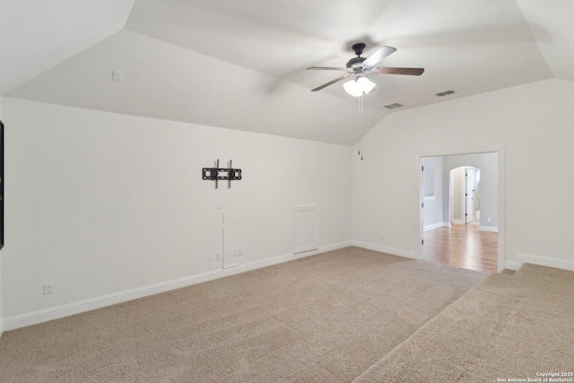 empty room with ceiling fan, carpet, and vaulted ceiling