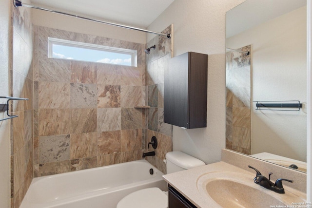 full bathroom featuring toilet, vanity, and tiled shower / bath